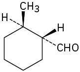 Cyclohexane ring in which one carbon has methyl (wedge) and H (dash) subtituents, and adjacent (clockwise) carbon has hydrogen (wedge) and C H O (dash) groups.